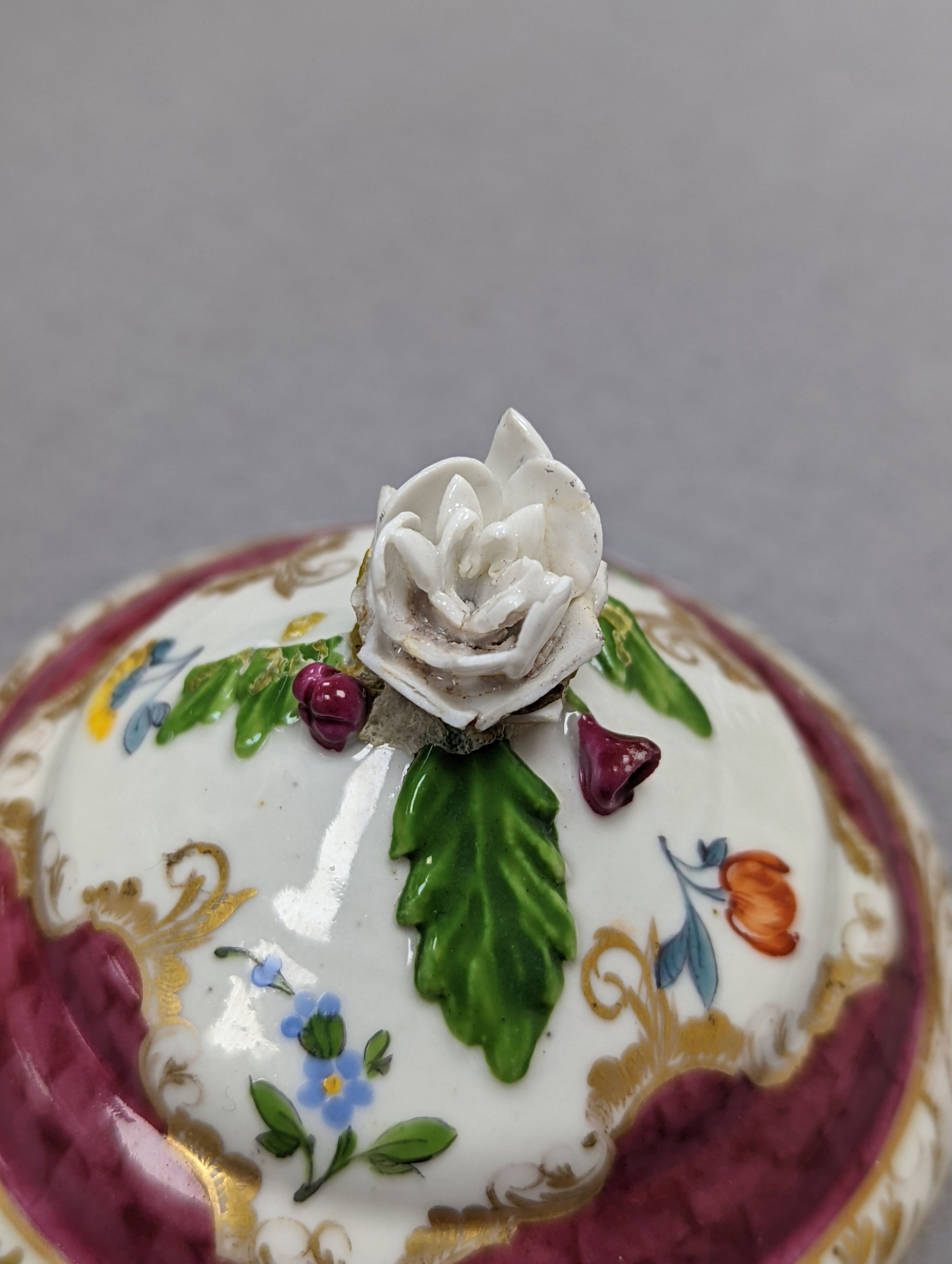 An 18th century Mennecy porcelain cup and cover, a Meissen style cup and cover, an English porcelain floral encrusted double inkwell and cover and a similar jar and cover